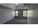 Bedroom featuring tray ceiling, carpet flooring, and natural light creating a cozy inviting space at 1395 Kala Dr, Lithonia, GA 30058