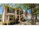 Two-story brick home featuring a two-car garage and mature landscaping, perfect for curb appeal at 1395 Kala Dr, Lithonia, GA 30058