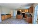 Kitchen with a center island, wood cabinets, granite counters, and modern appliances, flowing into the dining area at 1395 Kala Dr, Lithonia, GA 30058
