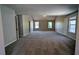 Spacious living room with neutral walls, carpet flooring and a ceiling fan creating a bright open space at 1395 Kala Dr, Lithonia, GA 30058
