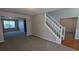 Spacious living room with neutral carpet, fresh paint, and a staircase leading to the upper level at 1395 Kala Dr, Lithonia, GA 30058