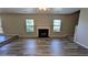 Bright living room with a fireplace and modern wood flooring throughout at 1395 Kala Dr, Lithonia, GA 30058