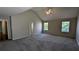 Large main bedroom with new carpet, a vaulted ceiling, and multiple windows at 1395 Kala Dr, Lithonia, GA 30058
