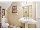 Traditional bathroom with pedestal sink, toilet, and decorative wall art at 4802 Moon Chase Dr, Buford, GA 30519