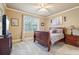 Bedroom with carpeted floor, cream trim, ceiling fan, and a window providing ample natural light at 4802 Moon Chase Dr, Buford, GA 30519