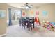 Bright dining room with a ceiling fan, window, wood table, and decor at 4802 Moon Chase Dr, Buford, GA 30519