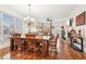 Open-concept dining area with hardwood floors, large windows, and backyard views at 4802 Moon Chase Dr, Buford, GA 30519