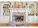 Elegant fireplace with stone surround, built-in shelving, and decorative accents at 4802 Moon Chase Dr, Buford, GA 30519