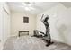 Carpeted gym featuring an elliptical machine, weight bench, and neutral walls at 4802 Moon Chase Dr, Buford, GA 30519