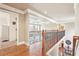 Hallway with hardwood floors, wood and metal railing, and an open view of the living room at 4802 Moon Chase Dr, Buford, GA 30519
