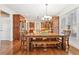 Charming eat-in kitchen with hardwood floors, lots of light, and a rustic wood table with bench seating at 4802 Moon Chase Dr, Buford, GA 30519