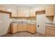 Kitchenette featuring light wood cabinets, a sink, and tile flooring at 4802 Moon Chase Dr, Buford, GA 30519