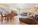 Living room with a leather sectional, television, and tile flooring at 4802 Moon Chase Dr, Buford, GA 30519