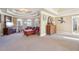 Living room showcasing a red chaise lounge, television and detailed trey ceiling at 4802 Moon Chase Dr, Buford, GA 30519