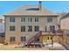 Two-story home featuring a deck, stairs, and a spacious backyard at 4802 Moon Chase Dr, Buford, GA 30519
