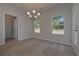 Open dining area with lots of light, wood floors and an elegant chandelier at 490 Charleston Pl, Villa Rica, GA 30180