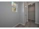 Hallway view to a closet and bright window at 490 Charleston Pl, Villa Rica, GA 30180