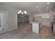Elegant kitchen with modern lighting, wood floor, granite island, and stainless appliances at 490 Charleston Pl, Villa Rica, GA 30180