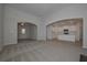Bright living room with carpet, archways, and a view of the modern kitchen at 490 Charleston Pl, Villa Rica, GA 30180