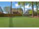 Beautiful backyard with a spacious lawn and mature trees offering shade at 823 Valley Dr, Canton, GA 30114