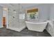 Modern bathroom featuring a standalone tub, a walk-in shower, and gray tile flooring at 823 Valley Dr, Canton, GA 30114
