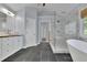 Bright bathroom featuring a freestanding tub, walk-in shower with marble tile, and double vanity at 823 Valley Dr, Canton, GA 30114