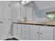 Bathroom boasting dual bowl sinks, shaker cabinets, granite countertops and natural light at 823 Valley Dr, Canton, GA 30114