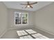 Bright bedroom showcasing a window letting in natural light and a ceiling fan at 823 Valley Dr, Canton, GA 30114