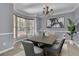 Elegant dining room featuring a bay window, chandelier, and seating for six, perfect for entertaining at 823 Valley Dr, Canton, GA 30114