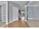 Entryway featuring hardwood floors, a staircase with white railings, and an open view to adjacent living spaces at 823 Valley Dr, Canton, GA 30114