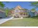 Inviting two-story home with a stone and stucco facade, a welcoming porch, and a well-manicured front yard at 823 Valley Dr, Canton, GA 30114