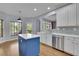 Bright kitchen with white cabinets, blue island, and hardwood flooring at 823 Valley Dr, Canton, GA 30114