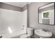 This bathroom features a shower over tub, modern sink, and a toilet at 1290 Campbellton Sw Rd, Atlanta, GA 30310