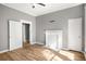 This bedroom features new wood floors, neutral walls, a ceiling fan and modern fireplace at 1290 Campbellton Sw Rd, Atlanta, GA 30310