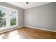 This bright bedroom features hardwood floors, neutral walls, and sun-drenched windows at 1290 Campbellton Sw Rd, Atlanta, GA 30310
