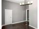 Cozy dining area with dark floors, neutral walls, modern lighting, and a connecting doorway at 1290 Campbellton Sw Rd, Atlanta, GA 30310