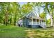 A charming home featuring a well-maintained lawn and mature trees at 1290 Campbellton Sw Rd, Atlanta, GA 30310