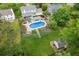 Backyard aerial view showcasing the pool, landscaped grounds, and a utility shed on a sunny day at 2724 Saddle Ridge Lake Dr, Marietta, GA 30062