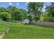 Green backyard featuring a utility shed, lush lawn, and a wooden privacy fence at 2724 Saddle Ridge Lake Dr, Marietta, GA 30062