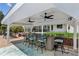 Outdoor bar and grill with ceiling fans, perfect for entertaining guests near the backyard at 2724 Saddle Ridge Lake Dr, Marietta, GA 30062
