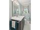 Charming bathroom featuring a vanity with chrome hardware, a decorative mirror, and a neutral color palette at 2724 Saddle Ridge Lake Dr, Marietta, GA 30062