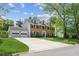 Charming brick home with dormer windows, attached two-car garage, and a beautifully landscaped front yard at 2724 Saddle Ridge Lake Dr, Marietta, GA 30062