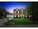 Inviting two-story brick home featuring manicured lawn, dormer windows, and attached two car garage at 2724 Saddle Ridge Lake Dr, Marietta, GA 30062
