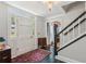 Bright foyer featuring black tiled floor, staircase, decorative rug, and elegant chandelier at 2724 Saddle Ridge Lake Dr, Marietta, GA 30062