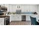 Bright kitchen showcasing white cabinets, stainless steel appliances, a blue glass tile backsplash, and hardwood floors at 2724 Saddle Ridge Lake Dr, Marietta, GA 30062