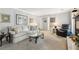 Cozy living room featuring neutral tones, a plush sofa, decorative artwork, and a glass coffee table at 2724 Saddle Ridge Lake Dr, Marietta, GA 30062
