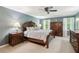 Tranquil main bedroom with a large bed, wooden furniture, and natural light from two windows at 2724 Saddle Ridge Lake Dr, Marietta, GA 30062