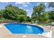 Beautiful backyard pool with steps, surrounded by lush greenery and a privacy fence for secluded enjoyment at 2724 Saddle Ridge Lake Dr, Marietta, GA 30062