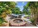 Inviting backyard pool area with outdoor seating, fire pit, and lush landscaping for relaxing and entertaining at 2724 Saddle Ridge Lake Dr, Marietta, GA 30062