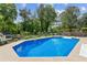 Lovely backyard pool surrounded by well-manicured landscaping, fencing for privacy, and room for leisure at 2724 Saddle Ridge Lake Dr, Marietta, GA 30062